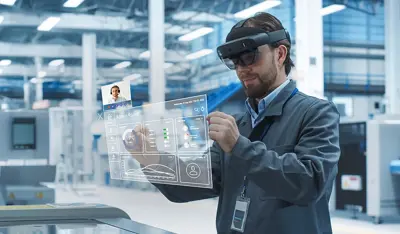 Production worker using VR for remote support on a manufacturing line.