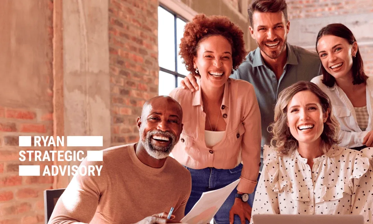 Smiling coworkers looking at camera while working in an industrial style office