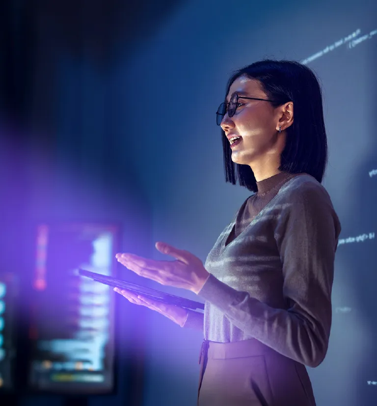 Woman using a tablet during a technology services presentation.