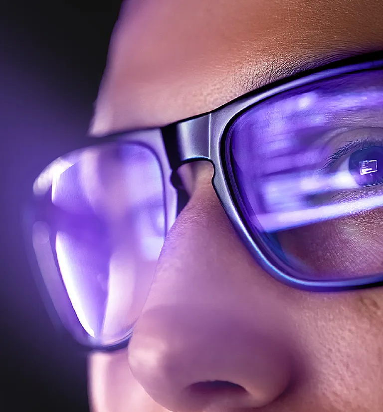 Person wearing glasses viewing digital data on screen for TP intelligent services.