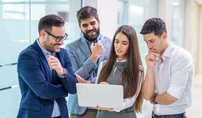 Team of employees collaborating in an office, representing late-stage debt recovery strategies.