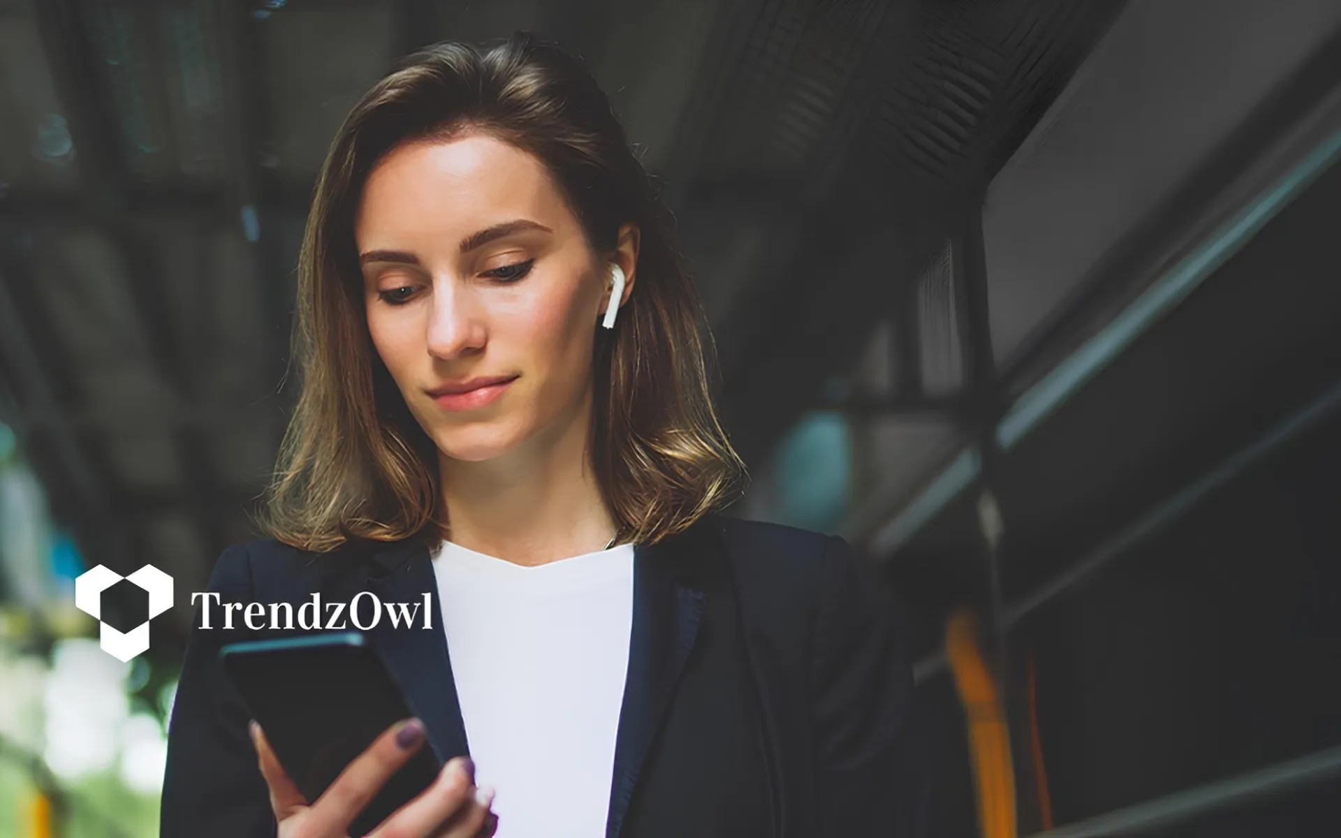 Businesswoman holding her phone, illustrating tech trends to watch in 2026 and beyond.